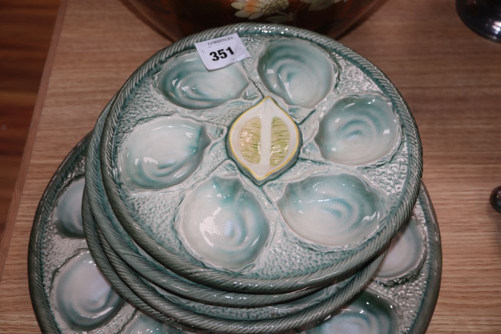 A set of four pottery oyster dishes, and a platter, the platter diameter 37cm